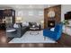 Cozy living room featuring a stone fireplace, stylish decor, and comfortable seating arrangements at 5445 Verbena St, Denver, CO 80238