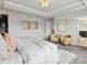 Bright, airy main bedroom with a white bed and decor, plus cozy chairs and a modern area rug at 5445 Verbena St, Denver, CO 80238