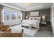 Main bedroom with lots of windows, tray ceiling, neutral gray walls and modern furniture at 5445 Verbena St, Denver, CO 80238