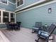 Inviting outdoor patio area with dining set and rocking chairs, perfect for relaxing and entertaining at 5445 Verbena St, Denver, CO 80238