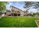 Spacious lawn with wooden fence and backyard access to the deck at 9548 La Quinta Dr, Lone Tree, CO 80124