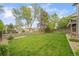 Large backyard featuring mature trees, a wooden fence and manicured lawn at 9548 La Quinta Dr, Lone Tree, CO 80124