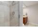 Modern bathroom featuring tiled walk-in shower and wooden vanity at 9548 La Quinta Dr, Lone Tree, CO 80124
