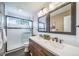 Beautiful bathroom with a double vanity, a shower with a glass door and modern fixtures at 9548 La Quinta Dr, Lone Tree, CO 80124