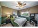 This spacious bedroom has a ceiling fan, neutral colors and a beautiful view from the large window at 9548 La Quinta Dr, Lone Tree, CO 80124