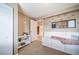Relaxing tan bedroom showcasing a built-in bench and decorative wall art at 9548 La Quinta Dr, Lone Tree, CO 80124