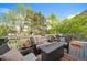 Outdoor deck with comfortable seating, a fire pit, and green tree views at 9548 La Quinta Dr, Lone Tree, CO 80124