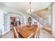 Open dining room showing wood floors, staircase, and an arched entrance to the kitchen at 9548 La Quinta Dr, Lone Tree, CO 80124