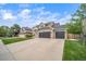 Charming two-story home with a three-car garage, and lush green lawn at 9548 La Quinta Dr, Lone Tree, CO 80124