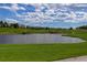 Scenic golf course with a tranquil lake surrounded by manicured greens and beautiful landscaping at 9548 La Quinta Dr, Lone Tree, CO 80124