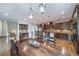 Open kitchen boasts dark wood cabinets, stone countertops, and island with seating at 9548 La Quinta Dr, Lone Tree, CO 80124