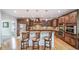 Modern kitchen with dark wood cabinetry, center island, stainless appliances at 9548 La Quinta Dr, Lone Tree, CO 80124