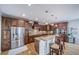 Stylish kitchen featuring dark wood cabinets, a center island, and stainless steel appliances at 9548 La Quinta Dr, Lone Tree, CO 80124