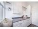 Spacious laundry room with white cabinets, countertop space, and extra storage; perfect for organization at 9548 La Quinta Dr, Lone Tree, CO 80124