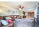 Bright living room featuring a plush rug, leather sofa and open layout to the kitchen at 9548 La Quinta Dr, Lone Tree, CO 80124