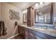 Dual-sink vanity in main bath featuring granite countertops and decorative mirrors at 9548 La Quinta Dr, Lone Tree, CO 80124