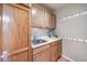 Mud room with cabinetry, hooks, and a utility sink for added convenience at 9548 La Quinta Dr, Lone Tree, CO 80124