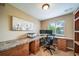 Home office with custom built-in desk, drawers, and shelving at 9548 La Quinta Dr, Lone Tree, CO 80124