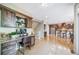 Office area with granite desktop and custom cabinets adjacent to a view of the kitchen and stairs at 9548 La Quinta Dr, Lone Tree, CO 80124