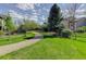 Walking path along manicured lawn and neighborhood trees at 9548 La Quinta Dr, Lone Tree, CO 80124