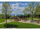 Community playground featuring slides, climbing structures, and benches with a mountain view backdrop at 9548 La Quinta Dr, Lone Tree, CO 80124