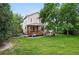 Backyard view of a two-story home featuring a spacious deck and well-maintained lawn at 4674 Winona Pl, Broomfield, CO 80020