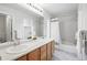 Bright bathroom with double sinks, large mirror, and a shower-tub combo at 4674 Winona Pl, Broomfield, CO 80020