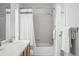 Clean bathroom with tiled shower-tub combo, updated fixtures, and a modern sink at 4674 Winona Pl, Broomfield, CO 80020