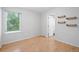 Bright bedroom with wood flooring, a door to an ensuite and a large window at 4674 Winona Pl, Broomfield, CO 80020