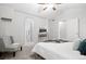 Bright bedroom with vaulted ceiling, neutral tones, and a modern chair near the ensuite bathroom entrance at 4674 Winona Pl, Broomfield, CO 80020