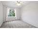 Sunlit bedroom with a large window and plush carpeting at 4674 Winona Pl, Broomfield, CO 80020