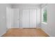 Bedroom with wood-look flooring, closet and a bright window at 4674 Winona Pl, Broomfield, CO 80020