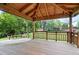 A spacious covered wooden deck with built-in benches and a view of the green yard at 4674 Winona Pl, Broomfield, CO 80020