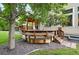 Wooden deck area featuring mature tree providing shade on a grassy lawn at 4674 Winona Pl, Broomfield, CO 80020
