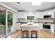 Modern kitchen with white cabinetry, stainless steel appliances, and access to the backyard at 4674 Winona Pl, Broomfield, CO 80020
