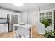 Bright kitchen featuring stainless steel appliances, a kitchen island, and hardwood floors at 4674 Winona Pl, Broomfield, CO 80020