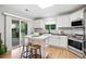 Bright kitchen boasts an island, stainless appliances, and access to the deck at 4674 Winona Pl, Broomfield, CO 80020