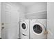 Laundry room with stacked washer/dryer and a floating shelf for supplies at 4674 Winona Pl, Broomfield, CO 80020