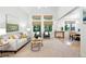 Bright and airy living room with vaulted ceilings, neutral decor, and view to dining room at 4674 Winona Pl, Broomfield, CO 80020
