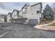 Gray townhouses with attached garages and landscaping at 19249 E Carolina Dr # 106, Aurora, CO 80017