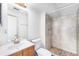 Updated bathroom featuring tiled floors, vanity, toilet, and tiled walk-in shower at 875 S Quebec St # 21, Denver, CO 80247