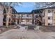 Apartment building with wood staircases and balconies on multiple floors at 875 S Quebec St # 21, Denver, CO 80247