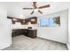 Well-lit kitchen featuring tile floors, dark cabinetry, and modern appliances at 875 S Quebec St # 21, Denver, CO 80247