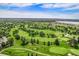 Breathtaking aerial shot of well-manicured golf course with tree-lined fairways and water features at 6500 W Mansfield Ave # 39, Denver, CO 80235