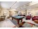 Finished basement with ping pong table and comfortable seating area at 6500 W Mansfield Ave # 39, Denver, CO 80235