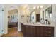 Modern primary bathroom features double sinks, spacious vanity, and access to the main bedroom, creating a spa-like retreat at 6500 W Mansfield Ave # 39, Denver, CO 80235