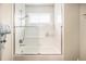 Bright bathroom featuring a shower-tub with a large clear glass sliding door at 6500 W Mansfield Ave # 39, Denver, CO 80235