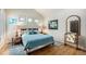 Bright bedroom with hardwood floors and a king-sized bed, as well as a quirky painting at 6500 W Mansfield Ave # 39, Denver, CO 80235
