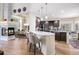 Open concept with bright kitchen, sleek island, and wood floors flowing into the living and dining areas at 6500 W Mansfield Ave # 39, Denver, CO 80235