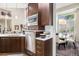 Modern kitchen with stainless steel dishwasher, microwave, ample storage, and adjacent dining area at 6500 W Mansfield Ave # 39, Denver, CO 80235